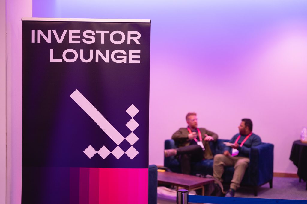 A speaker in a panel discussion on stage at Turing Fest