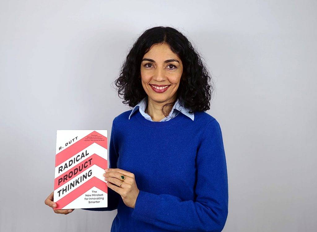 Radhika Dutt holding her book Radical Product Thinking